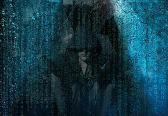 Dark, hooded figure behind a foreground that might be water-streaked glass or the pattern from the Matrix. Image by Eden Moon from Pixabay